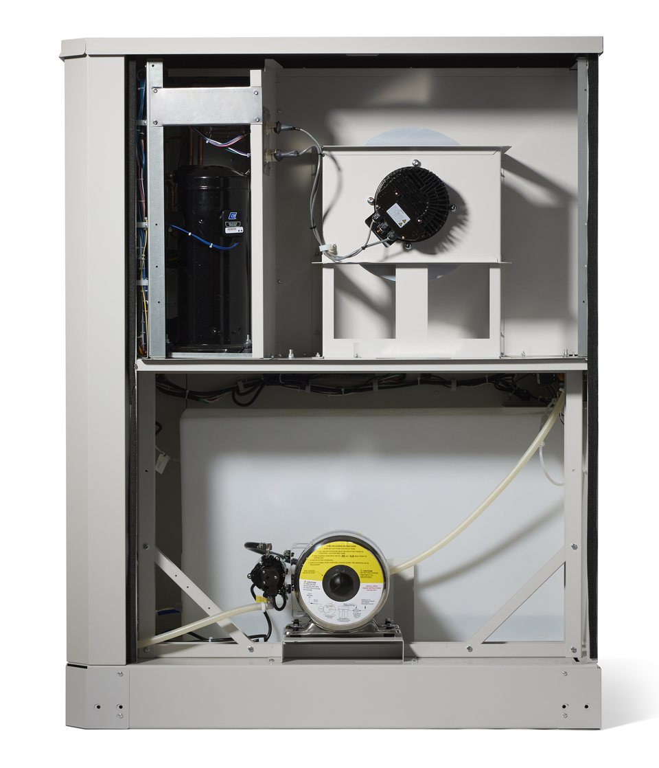 Inside an Origen Wellspring 100 atmospheric water generator — compressor, blower, food-safe storage vessel and pump of a real AWG, not a render