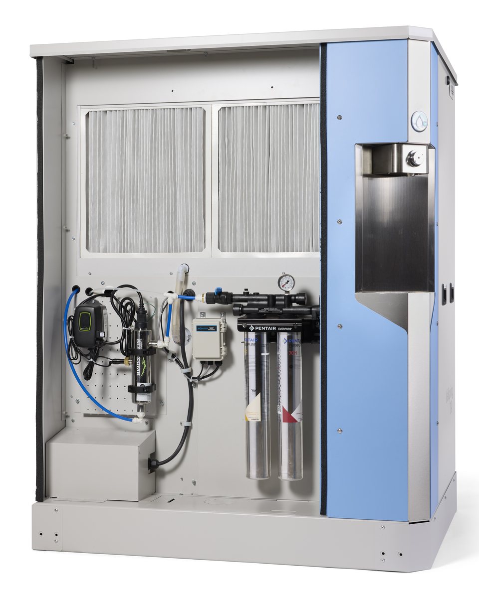 Origen atmospheric water generator service bay open — Pentair Everpure filtration, UV-C sterilizer and controls inside the AWG